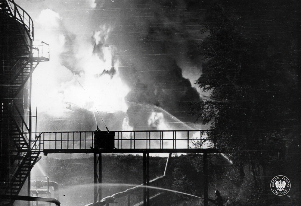 Strażacy gaszący pożar w rafinerii w jego pierwszej fazie, przed katastrofalnym wybuchem. Fotografię wykonano 26 VI 1971 r. między godziną 21 a 24 (IPN Ka 093/299)